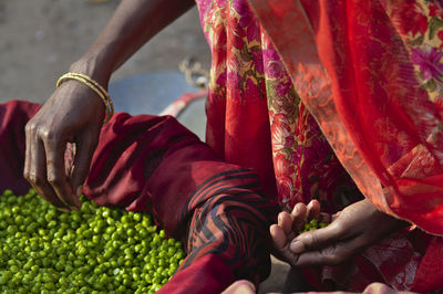 Midsection of people having food outdoors