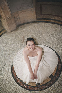 High angle view of bride siting on floor