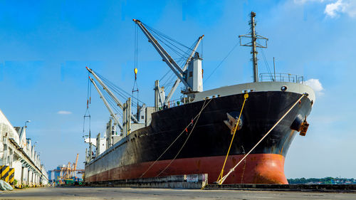 Commercial dock by sea against sky