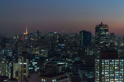 Aerial view of city lit up at night