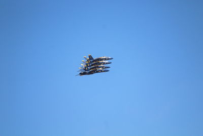 Low angle view of helicopter flying in sky