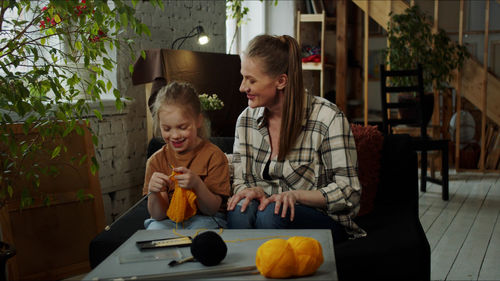 Portrait of smiling family sitting at home