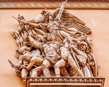 Low angle view of statue against wall