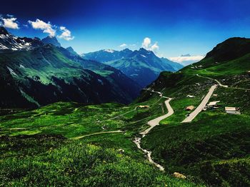 Scenic view of mountains against blue sky