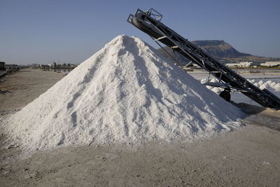 Heap of salt at mine against sky