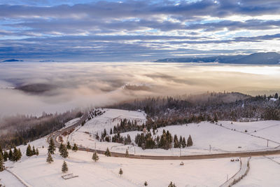 Scenic view of snow covered landscape against sky