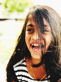 Close-up of girl laughing while looking away