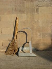 Broom and dust pan leaning on wall