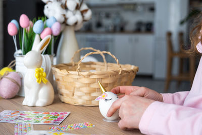 Midsection of woman putting coin on table