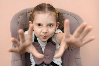 Portrait of young woman against white background