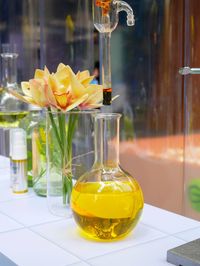Close-up of yellow flower in vase on table