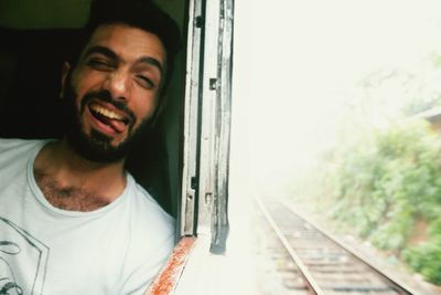 Portrait of young man in train