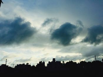 Silhouette of building against cloudy sky