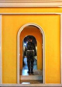 Man standing by door of building