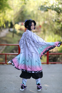 Japan anime cosplay portrait of girl with comic costume with japanese theme garden