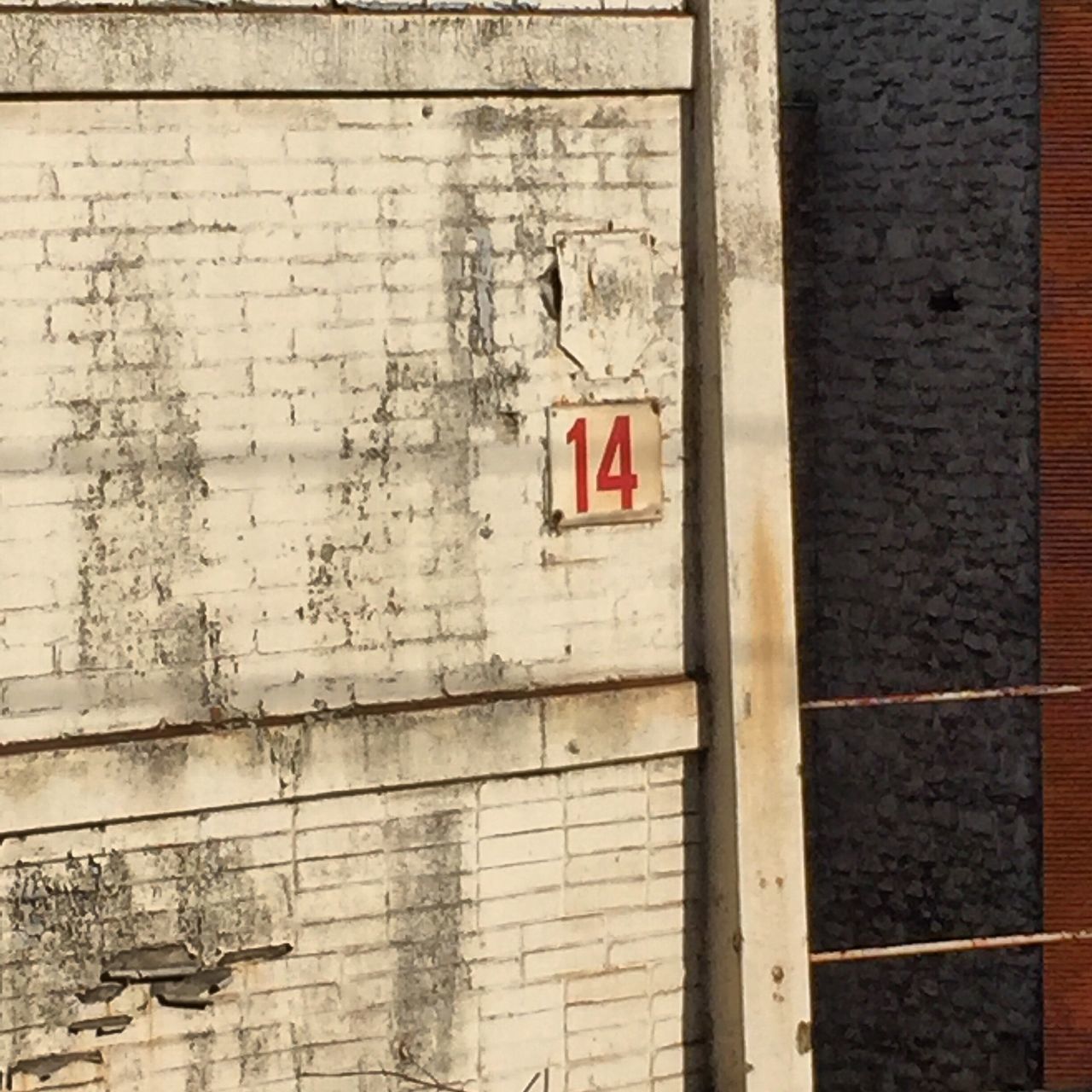 architecture, built structure, wall - building feature, brick wall, building exterior, text, wall, western script, communication, weathered, old, day, brick, graffiti, no people, outdoors, damaged, textured, building, stone wall