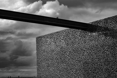 Low angle view of building against cloudy sky