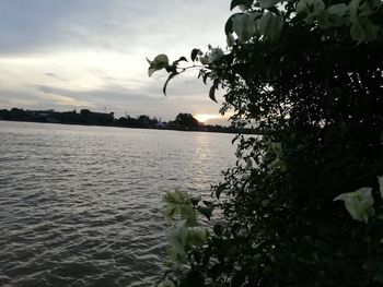 Scenic view of lake against sky at sunset