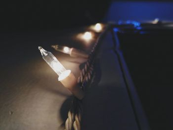 Close-up of hand holding illuminated lamp