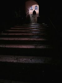 Low angle view of woman walking on staircase in building