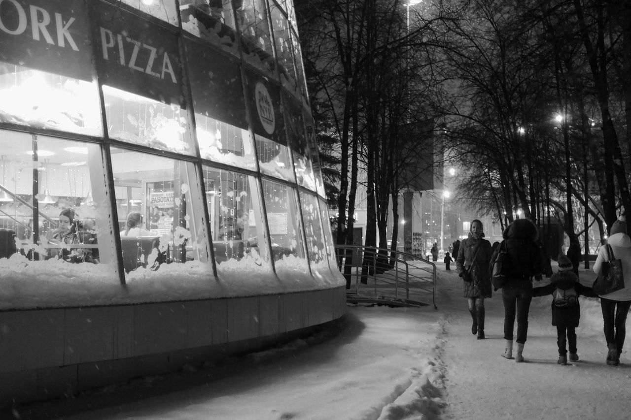 men, illuminated, night, street, walking, lifestyles, person, city life, building exterior, architecture, city, built structure, transportation, the way forward, leisure activity, full length, winter, rear view, season