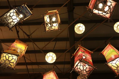 Low angle view of illuminated lanterns hanging on ceiling