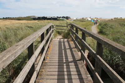 Landscape walberswick suffolk uk beach wooden crabbing bridge towards campsite over sand dunes 