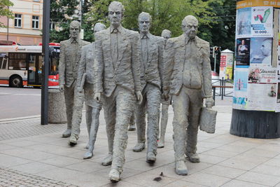 Statues on street in city