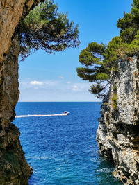 Small cove in rocky coast. sea, summer, boat.