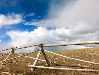 Wind turbines on field against sky