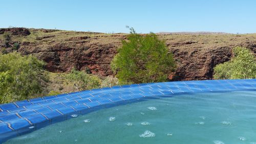 Scenic view of swimming pool against clear blue sky