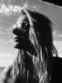 Close-up of woman with sunglasses against sky