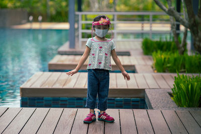 Rear view of boy on pier