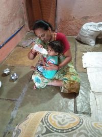 High angle view of mother and daughter outdoors