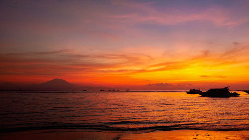 Scenic view of sea against orange sky