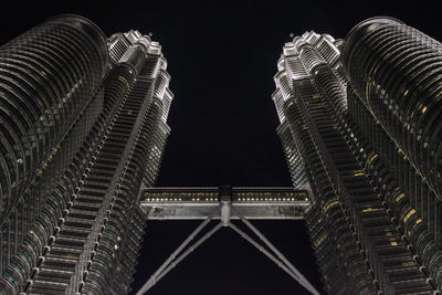 Low angle view of illuminated buildings against sky at night