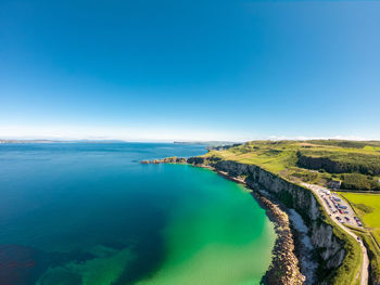 Scenic view of sea against clear blue sky