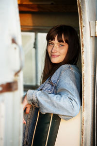 Portrait of woman sitting in camper van