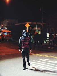 Full length of man walking on road at night