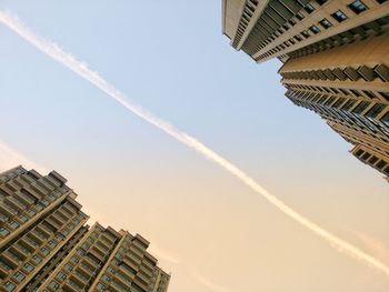 Low angle view of buildings against sky during sunset