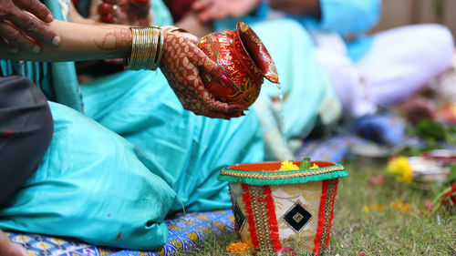 Low section of couple performing traditional ritual