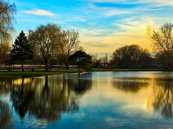 Scenic view of lake against sky at sunset
