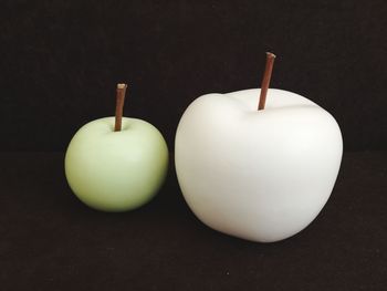 Close-up of apple on table against black background