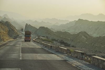 Road amidst mountains against sky