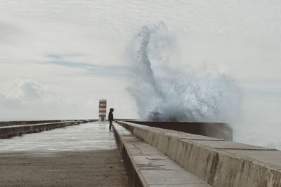 Scenic view of wave splashing pier