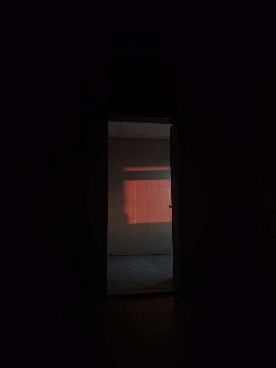 OPEN DOOR OF BUILDING WITH DARK ROOM