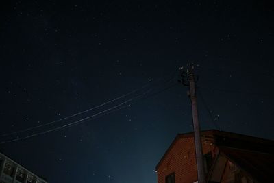 Low angle view of cables against sky at night