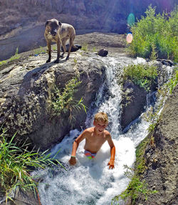 Full length of woman splashing water