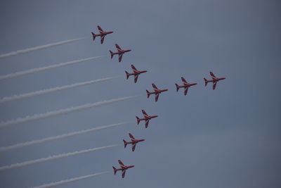 Low angle view of airshow against sky