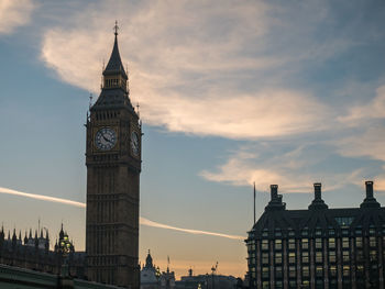 Low angle view of clock tower in city against sky